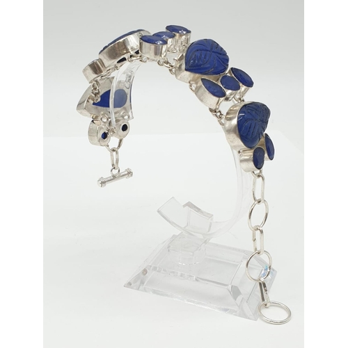 32 - A statement bracelet with carved, transluscent, cabochon sapphires.
Bracelet length: 19cm (max), wei... 