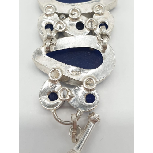 32 - A statement bracelet with carved, transluscent, cabochon sapphires.
Bracelet length: 19cm (max), wei... 