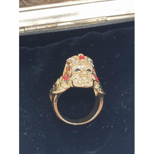 47 - A ring depicting a Venetian Carnival Mask and a pair of earrings in a metal, Renaissance style box. ... 