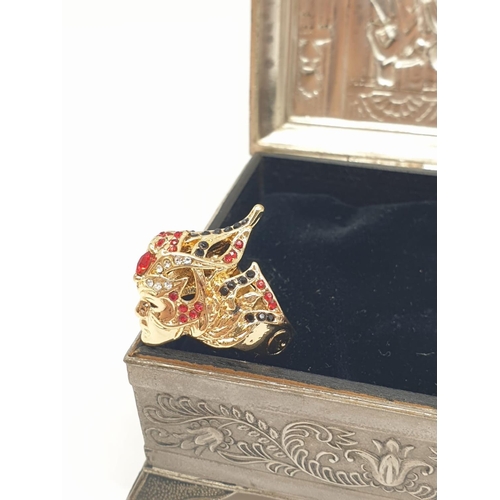 47 - A ring depicting a Venetian Carnival Mask and a pair of earrings in a metal, Renaissance style box. ... 