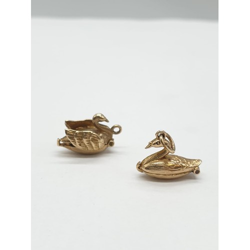 247 - Two 9ct gold charms/pendants of 2 swans. One opens up to show ballerina dancing inside. Length 1cm. ... 