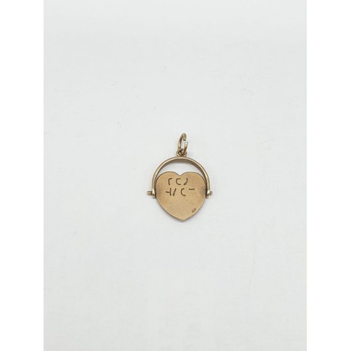 275 - 9ct gold pendant. Rotating heart to read 'I Love You'. Length 2cm. Weight 1.24g