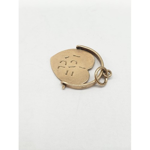 275 - 9ct gold pendant. Rotating heart to read 'I Love You'. Length 2cm. Weight 1.24g