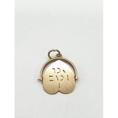 275 - 9ct gold pendant. Rotating heart to read 'I Love You'. Length 2cm. Weight 1.24g