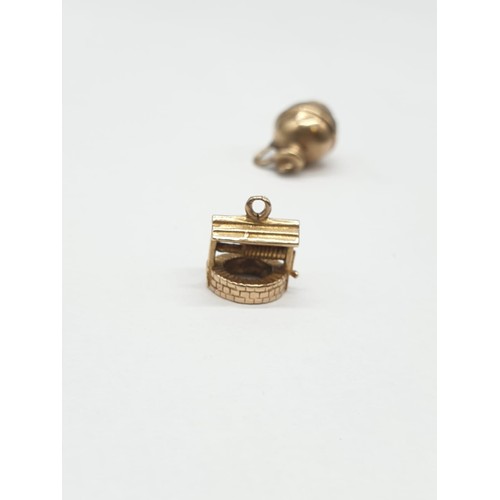 303 - 2 x 9ct gold pendants, Wishing Well and a Water Jug.  1.5cm in height. Weighs 2.6g