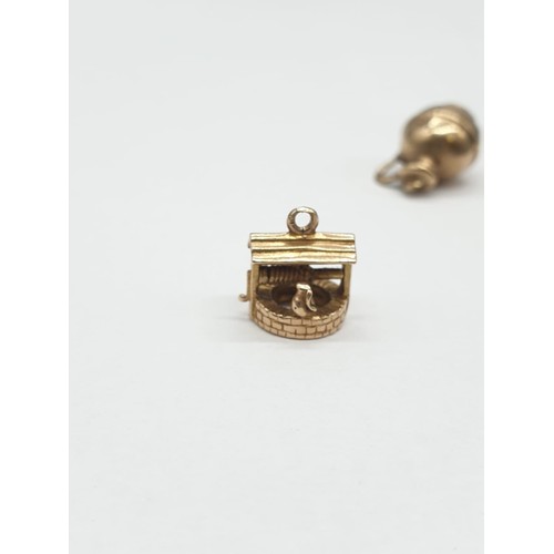 303 - 2 x 9ct gold pendants, Wishing Well and a Water Jug.  1.5cm in height. Weighs 2.6g