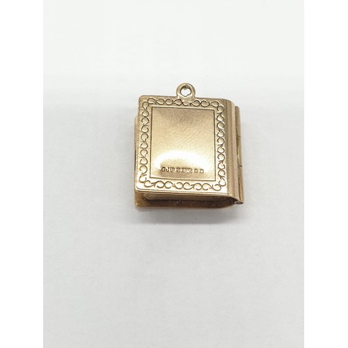 331 - 9ct gold 'Holy Bible' charm/pendant. length 1.5cm. Weight 2.67g