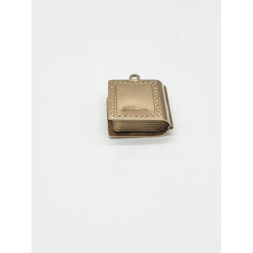 331 - 9ct gold 'Holy Bible' charm/pendant. length 1.5cm. Weight 2.67g