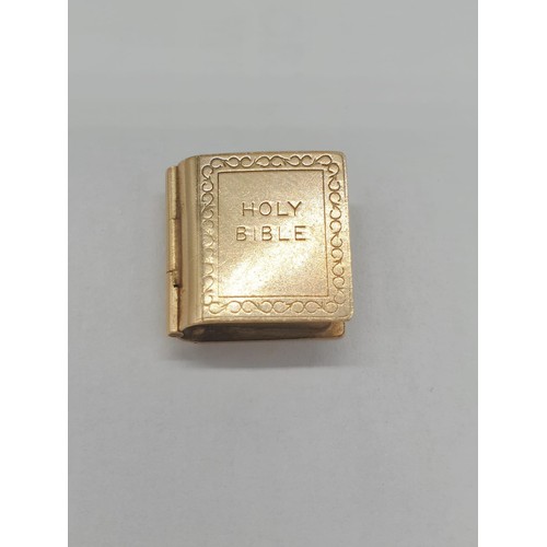 331 - 9ct gold 'Holy Bible' charm/pendant. length 1.5cm. Weight 2.67g