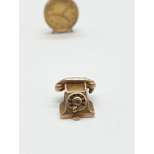 338 - Three 9ct gold charms/pendants of an old fashioned telephone, tv and alarm clock. Size of Clock is 2... 