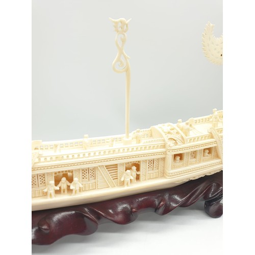 227 - Antique Chinese ivory barge with many carved figures on original wooden base, 26 x 17 x 4cm approx