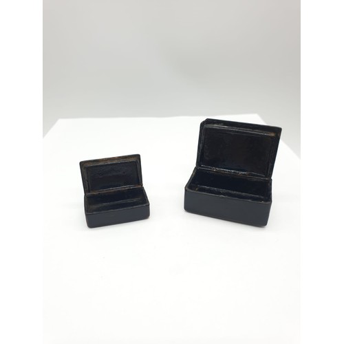 179 - Two antique tiny snuff boxes. Made from lacquered papier mache, hinged lid with pewter inlay.