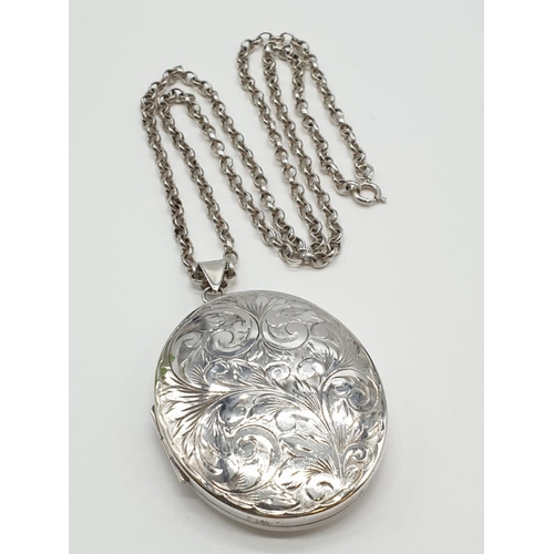 112 - Vintage Large Silver Locket having scroll work to front. Mounted on a long silver belcher type chain... 