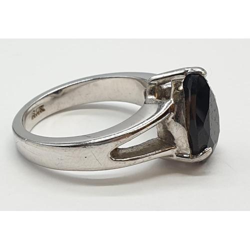 13 - Silver Ring, with brown topaz pear shaped stone in silver claw mount. Pierced shoulders and clear ma... 