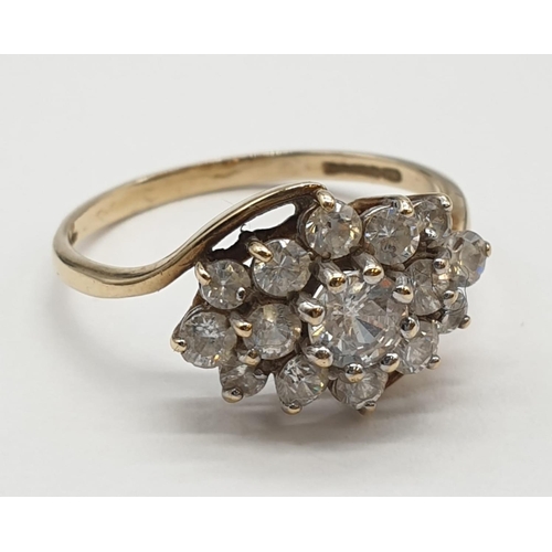 134 - 9ct gold cluster ring having crossover gold band. Size Q1/2. 2.8 grams. Full UK hallmark.