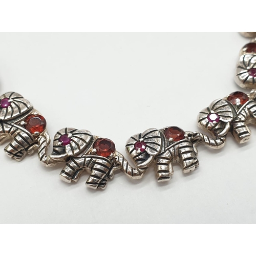 98 - Silver gem set, elephant bracelet. Stones test as tourmaline. 19.5cm approx.