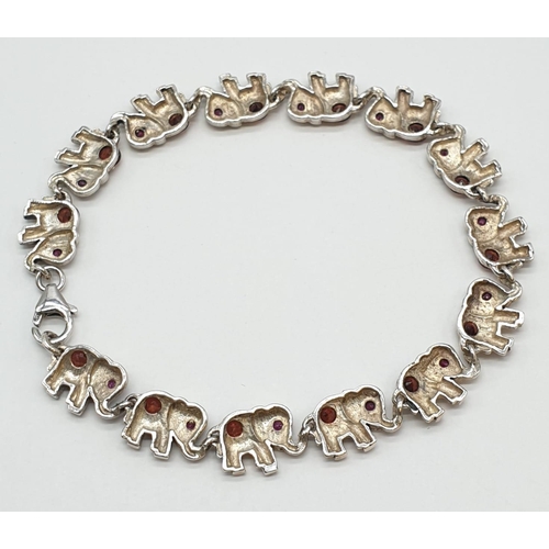 98 - Silver gem set, elephant bracelet. Stones test as tourmaline. 19.5cm approx.