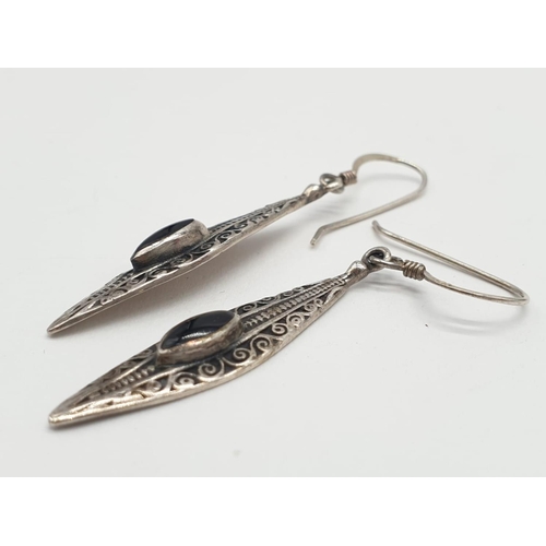 117 - A pair of silver and black onyx earrings. Boat shaped. Marked 925 silver. Gift boxed.