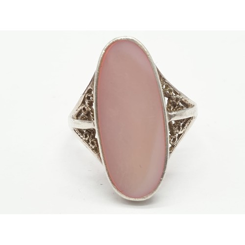 299 - Silver ring having large pink stone to top. Attractive Filigree work to shoulders. Size N1/2 .