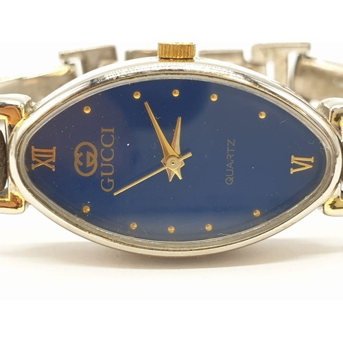 376 - Ladies wristwatch marked Gucci . Oval blue face model. Having quartz movement and 'gold' tone and ch... 