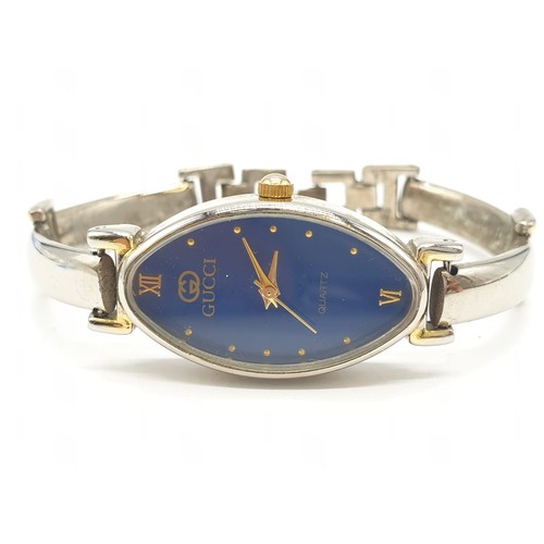 376 - Ladies wristwatch marked Gucci . Oval blue face model. Having quartz movement and 'gold' tone and ch... 