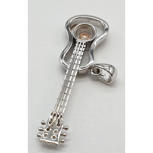 308 - 9ct white gold guitar pendant with great detailing and small centre diamond. Length 3cm. Weight 2.4 ... 