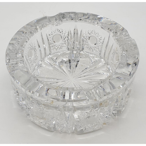 334 - Heavy glass ashtray with etching to to surround and bottom. 15cm x 6cm.