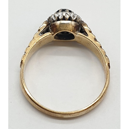 489 - 9ct gold ring with centre sapphire and diamond surround. Size P. Weight 3.15 grams