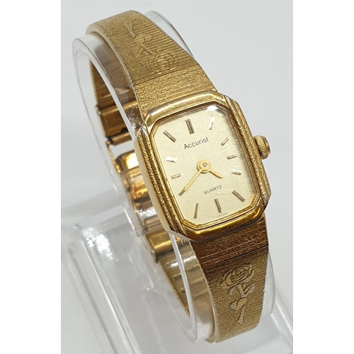 686 - A ladies gold colour Accurist quartz watch with 2 x rose motif on strap.