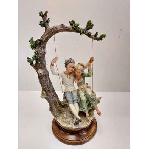 A Giuseppe Armani Capodimonte, 'Lovers on a Swing' figurine. 45cm in height.