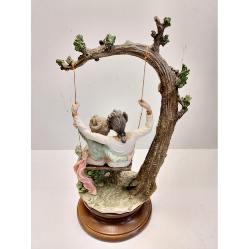 90 - A Giuseppe Armani Capodimonte, 'Lovers on a Swing' figurine. 45cm in height.