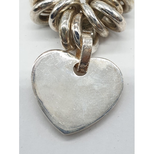 143 - Links of London style silver bracelet with heart charm. 77.5 grams. 17cm in length.