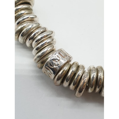 143 - Links of London style silver bracelet with heart charm. 77.5 grams. 17cm in length.