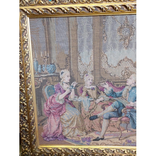 264 - A French Rococo parlour scene tapestry in a gold baroque-style frame. 114 x 62cm.