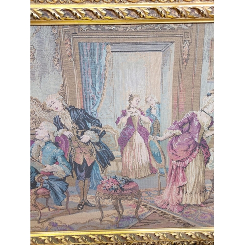 264 - A French Rococo parlour scene tapestry in a gold baroque-style frame. 114 x 62cm.