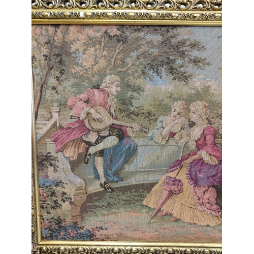 269 - A French Rococo tapestry depicting gaiety in the garden, in a gold baroque style frame. 100 x 54cm.