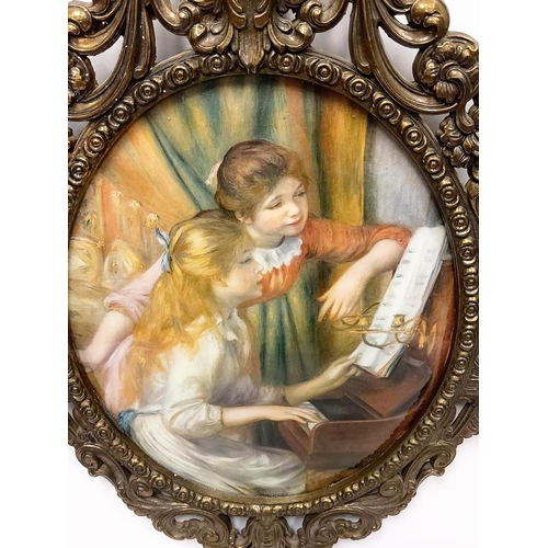 290 - An Italian Rococo styled frame encapsulating Renoir's 'Young girls at the piano'. 31cm wide.