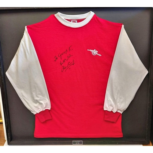 502 - A signed Liam Brady, framed football shirt. (glass missing on frame).