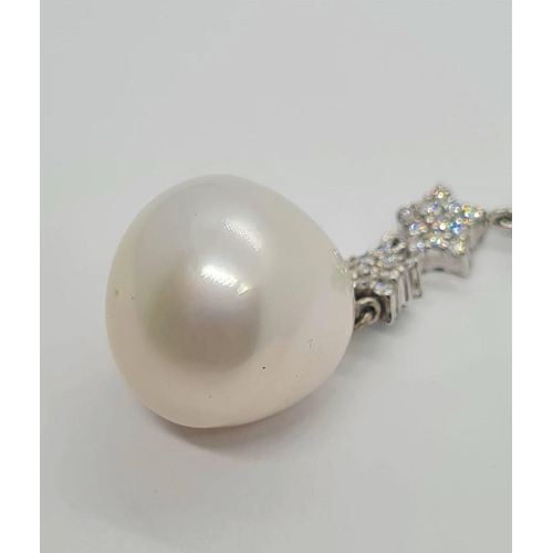 523 - A large Baroque pearl (14mm) and diamond pendant set in 18ct gold, weight 8.5g and 5cm drop approx