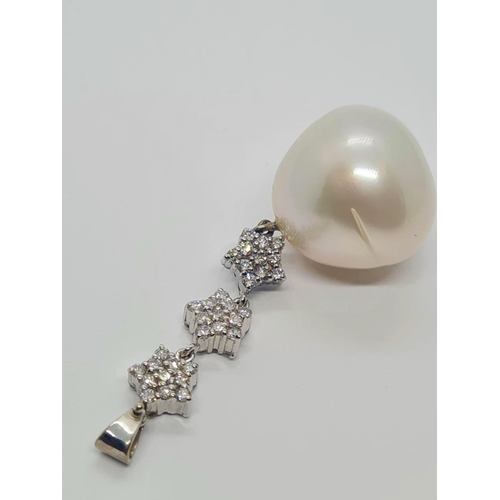 523 - A large Baroque pearl (14mm) and diamond pendant set in 18ct gold, weight 8.5g and 5cm drop approx