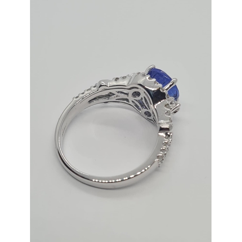 533 - 18CT WHITE GOLD RING WITH 1.8CT TANZANITE AND DIAMOND ENCRUSTED, WEIGHT 4.9G AND SIZE N