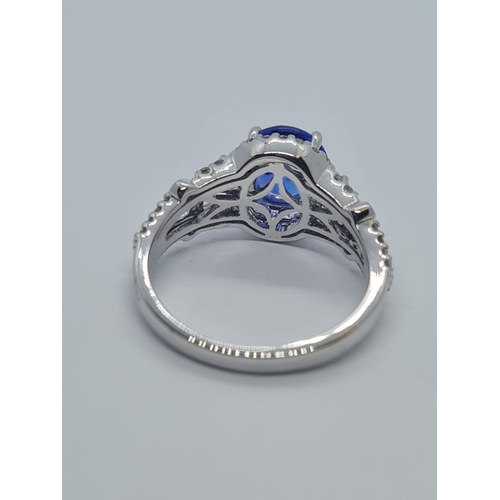 533 - 18CT WHITE GOLD RING WITH 1.8CT TANZANITE AND DIAMOND ENCRUSTED, WEIGHT 4.9G AND SIZE N