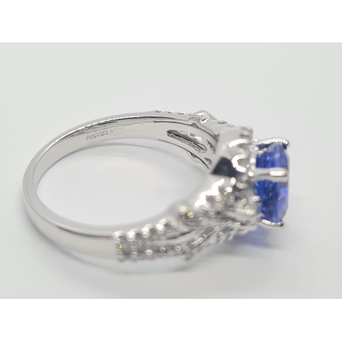 533 - 18CT WHITE GOLD RING WITH 1.8CT TANZANITE AND DIAMOND ENCRUSTED, WEIGHT 4.9G AND SIZE N