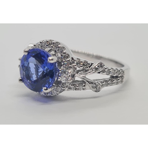 533 - 18CT WHITE GOLD RING WITH 1.8CT TANZANITE AND DIAMOND ENCRUSTED, WEIGHT 4.9G AND SIZE N