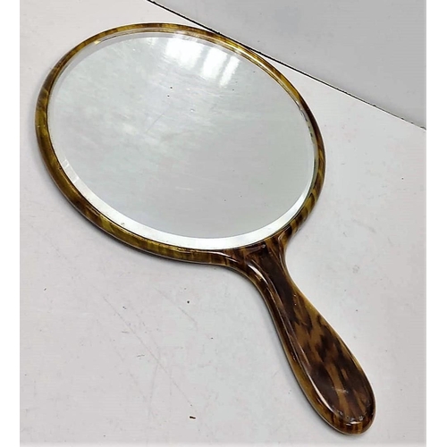 549 - Faux tortoiseshell vintage oval hand mirror. 15cm diameter.