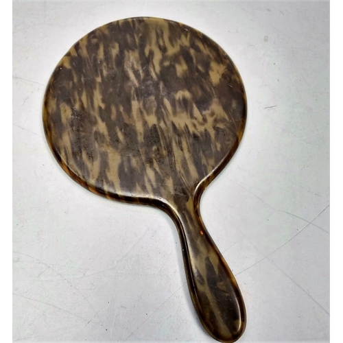 549 - Faux tortoiseshell vintage oval hand mirror. 15cm diameter.