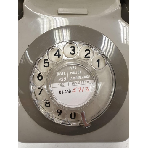 614 - Grey retro-phone with coil cord handset and turn dial. 11.5 x 14cm (24.5cm handset).