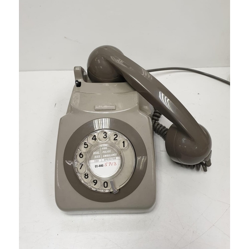 614 - Grey retro-phone with coil cord handset and turn dial. 11.5 x 14cm (24.5cm handset).