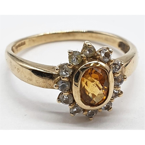 481 - 9ct gold ring having faceted citrine to top with clear stone surround. Full Birmingham 9ct hallmark.... 