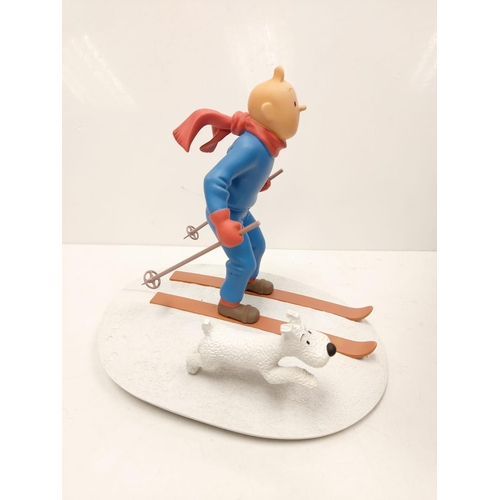 587 - A Tin Tin Herge Moulinsart model of Tin Tin skiing with Snowy. Good condition with box and comes wit... 